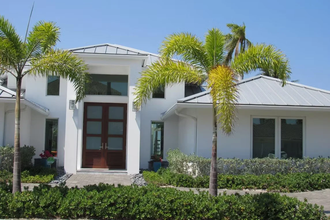 Modern house entrance with dark wood double front door